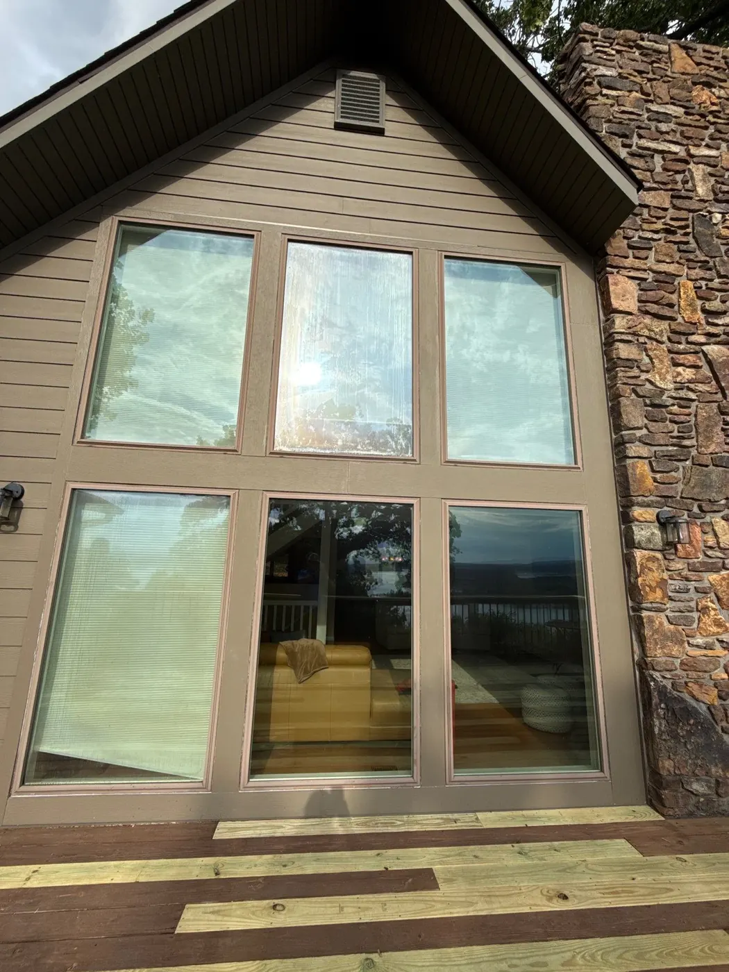 Before: the original window wall had smaller panes and a heavier visual break between the interior and exterior.